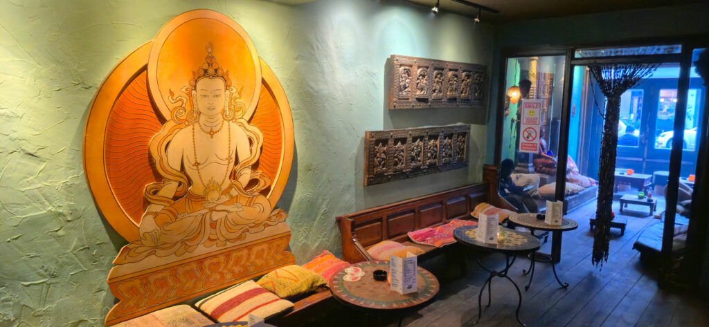 Daylight on the window seat with colourful cushions and a Buddha statue